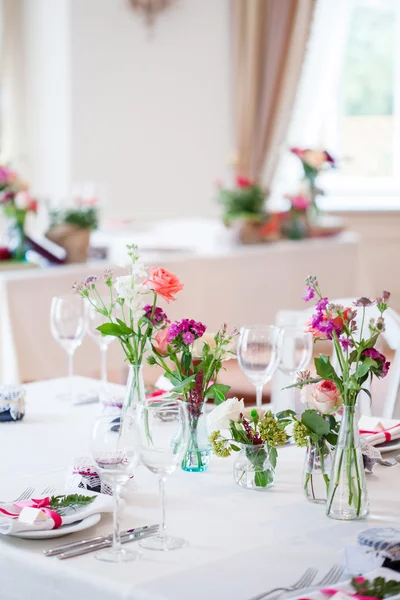 Wedding banquet, small restaurant. Floral decor in red, informal style.