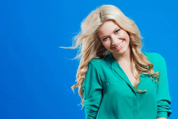 Portrait of young happy blonde, casual style, blue background
