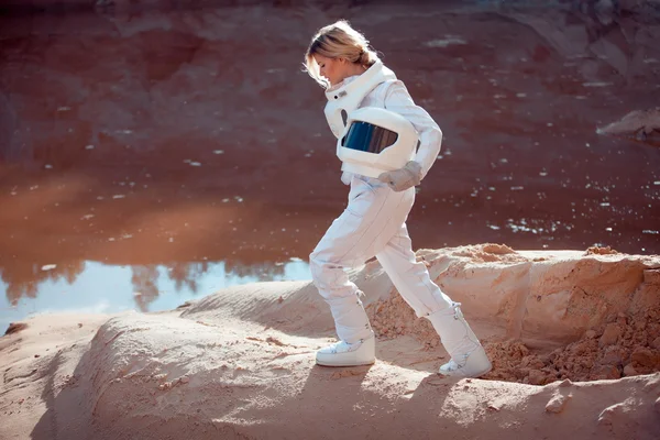 Water on Mars, futuristic astronaut without a helmet in another planet, image with the effect of toning