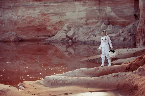 Water on Mars, futuristic astronaut without a helmet in another planet, image with the effect of toning