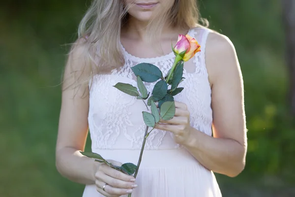 Young beautiful woman florist. The girl in the Park draws a bouquet. Outdoor