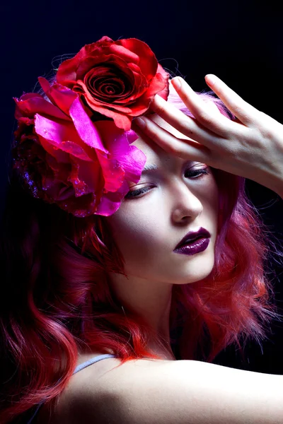 Beautiful girl with pink hair, large rose flower in her hair