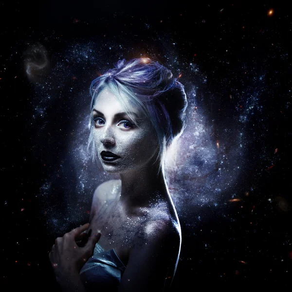 Unusual girl with bright fashion makeup, creative body art on theme space and stars. Elements of this image furnished by NASA.