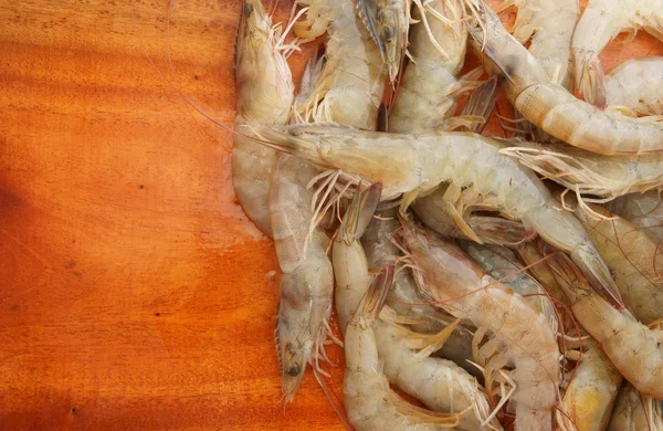 Fresh shrimps background on old wooden background
