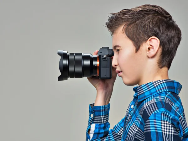 Boy with photo camera taking pictures