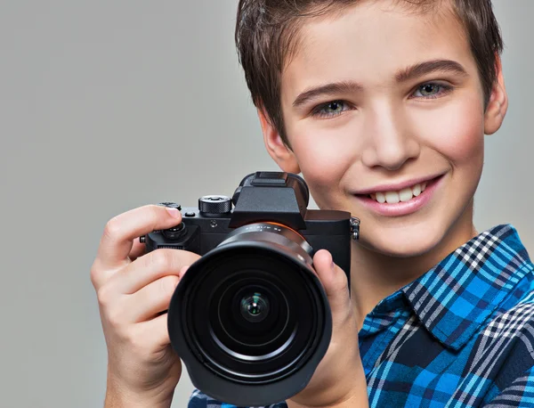 Boy with photo camera taking pictures