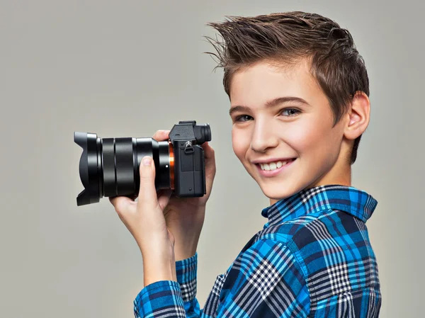 Boy with photo camera taking pictures