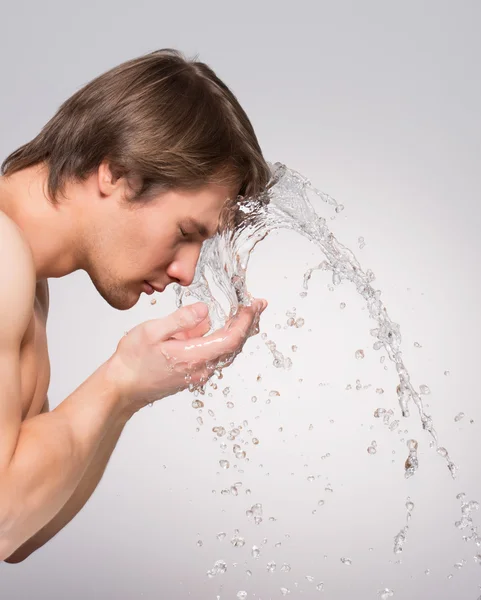 Man washing face.