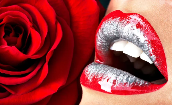 Female lips with shiny lipstick and rose