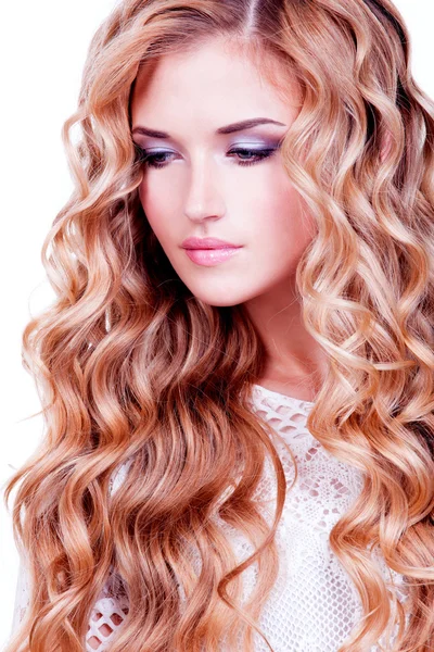 Model with long  curly hair.