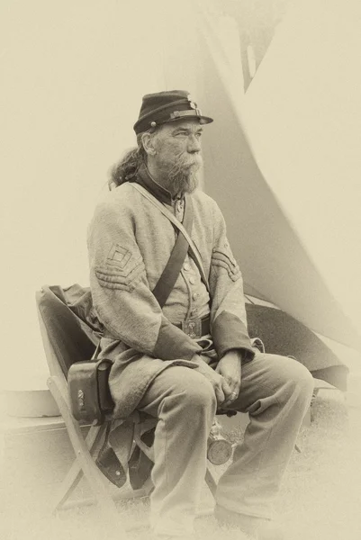 A Confederate sergeant waits by his tent before battle,