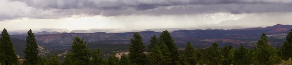 Panorama, morning thunderstorms over desert mountains