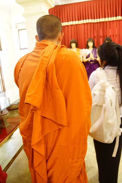 Buddhist monk checking cellphone