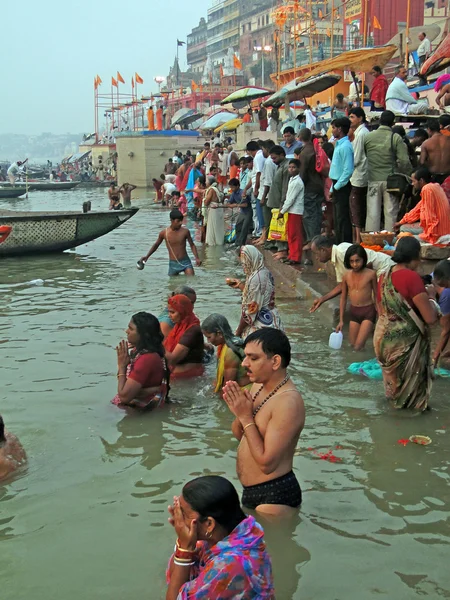 Hindus perform ritual puja at dawn in the Ganges River