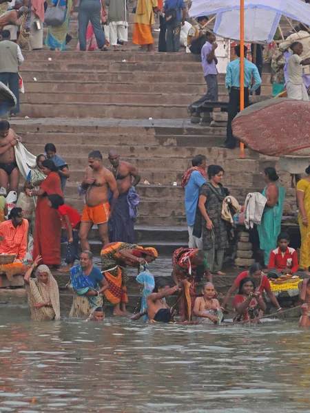Hindus perform ritual puja at dawn in the Ganges River