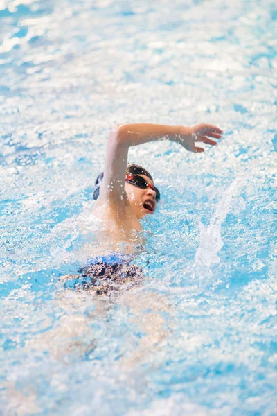 Teen boy training in swimming