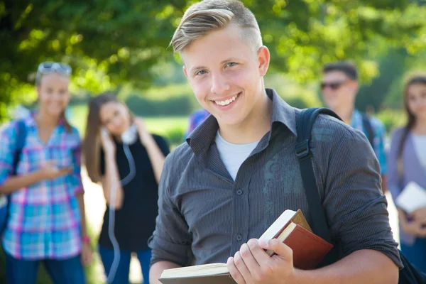 Student with books in park