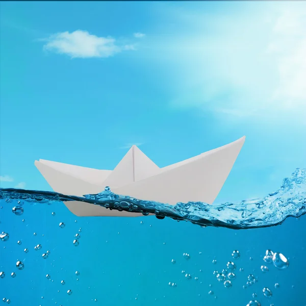 Origami boat floating in the water