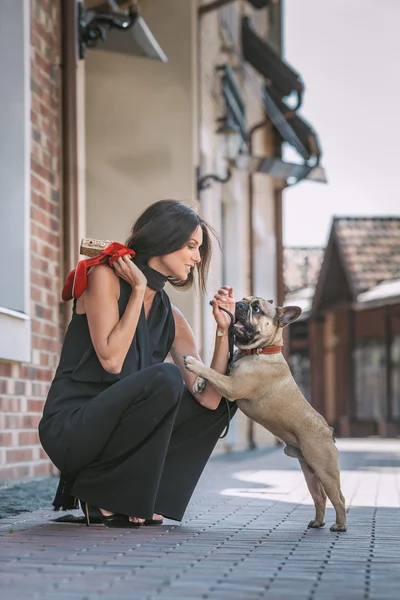 Beautiful  woman with dog on the street