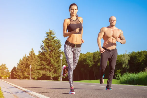 Man and woman running in park