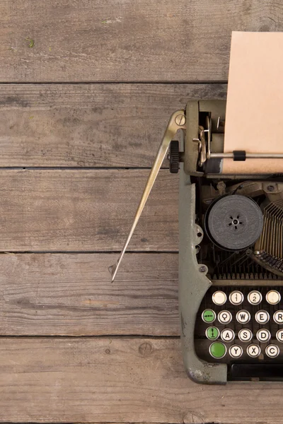 Vintage typewriter on the old wooden desk