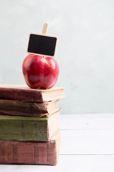 Apple on a stack of books on the table