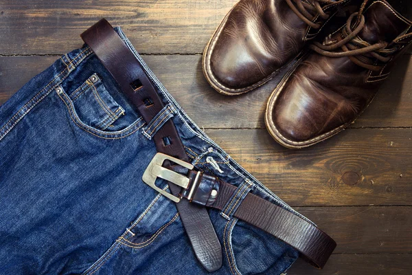 Jeans belt and shoed set on wood