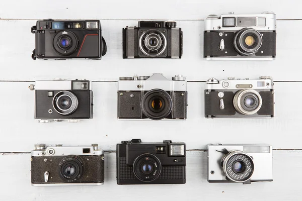 Set of vintage film cameras on wooden table