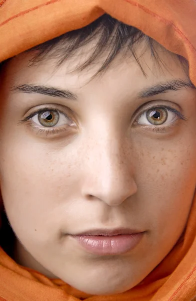 Orange veil woman with beautiful eyes, studio picture
