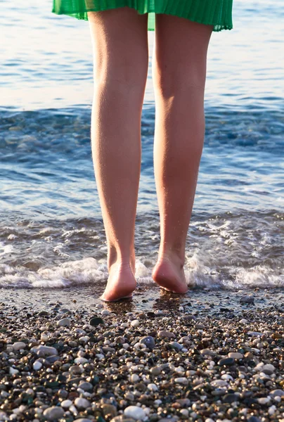 Nice legs of a pretty girl walking in water
