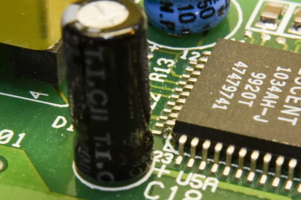 Circuit board with black and blue capacitors