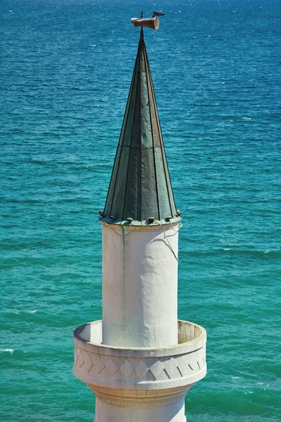 Minaret against the Sea Background