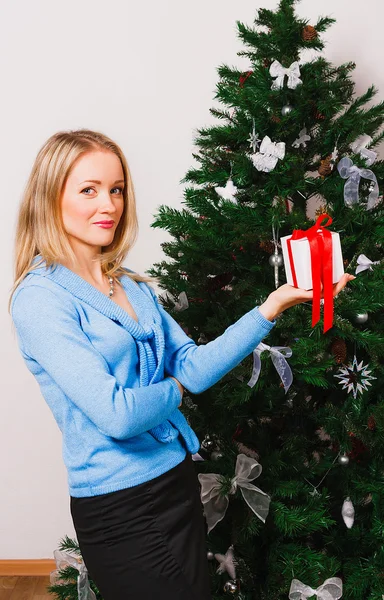 Woman holding gift on outstretched arm