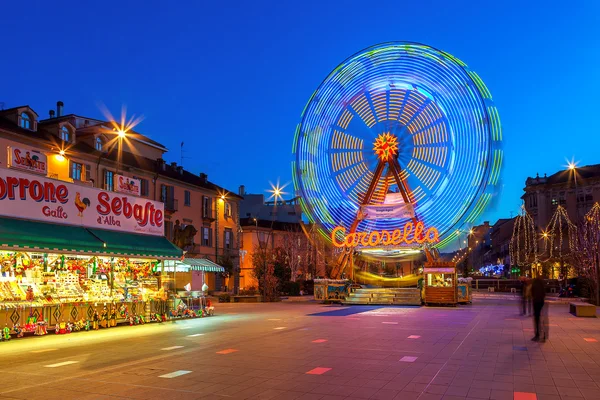 Observation wheel on town square in Alba, Italy.