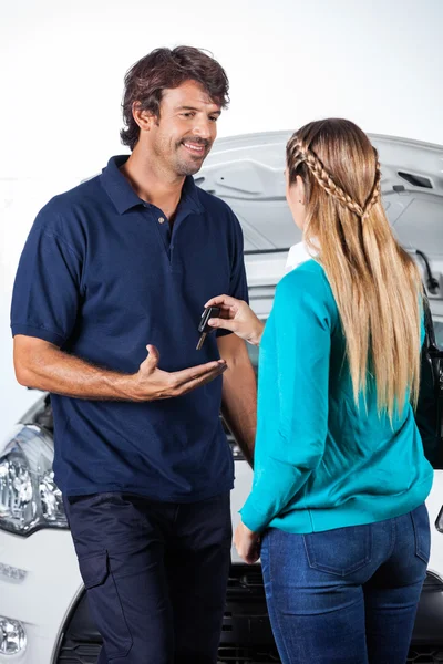 Client Giving Car Keys To Mechanic
