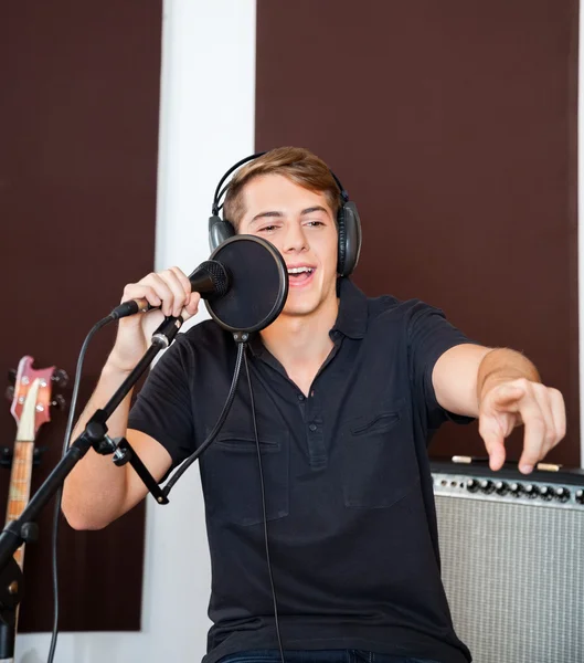 Young Male Singer Performing In Studio