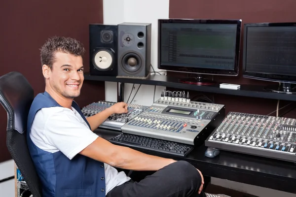 Portrait Of Young Man Mixing Audio In Recording Studio
