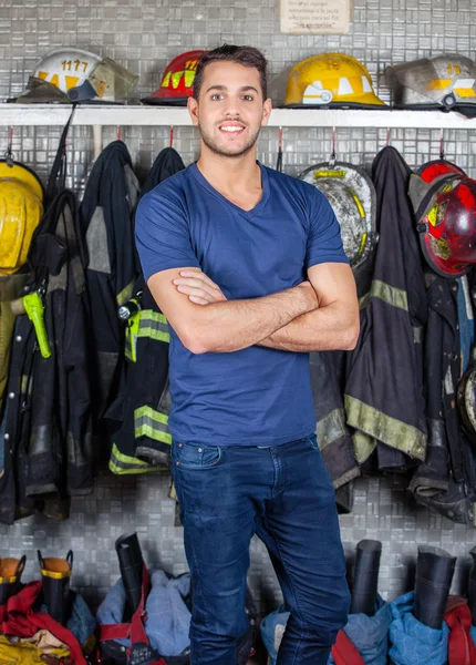Smiling Firefighter Standing At Fire Station