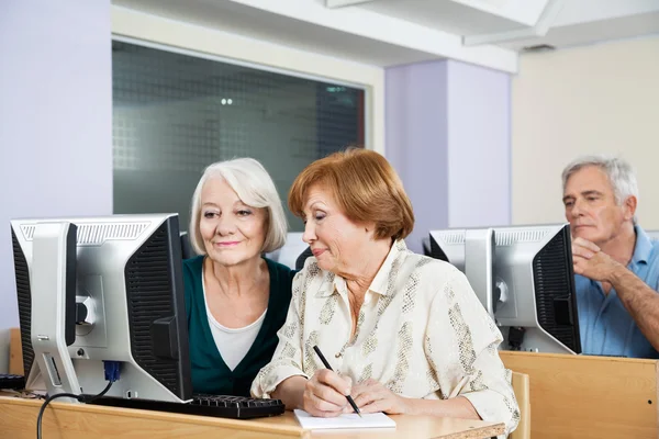 Senior Women Using Computer In Classroom