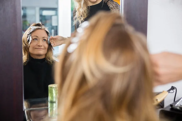 Mature Woman Having Hair Dyed At Beauty Parlor