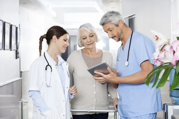 Physiotherapist Showing Reports To Patient And Doctor On Digital