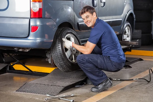 Happy Mechanic Fixing Car Tire