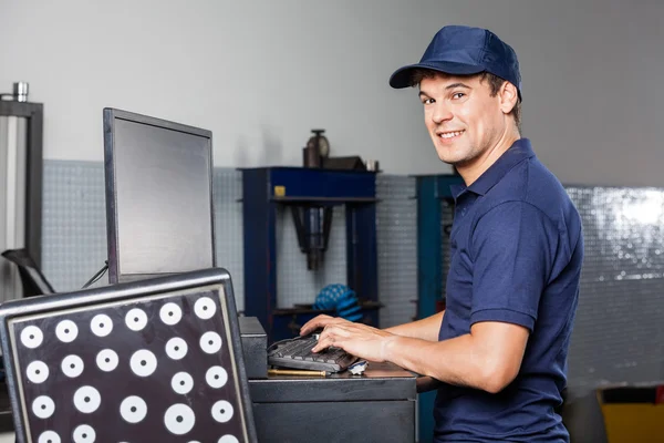 Mechanic Using Computer In Auto Repair Shop