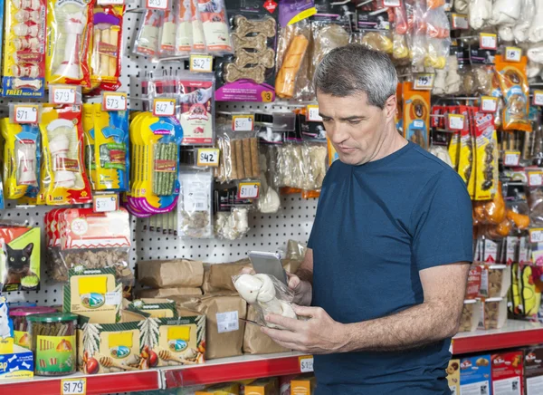 Man Scanning Barcode Of Dog Chew Bone