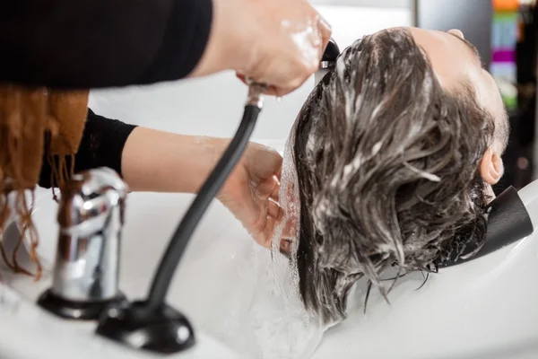 Man Having Hair Washed In Salon
