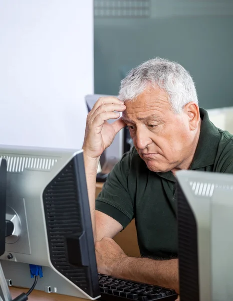 Depressed Senior Student Looking At Computer