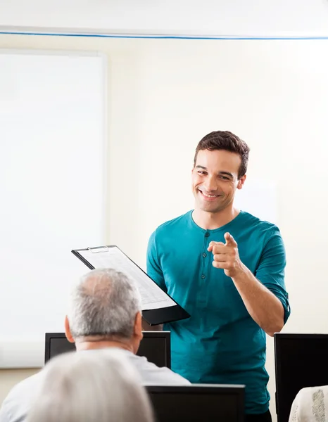 Happy Tutor Taking Lecture In Computer Class