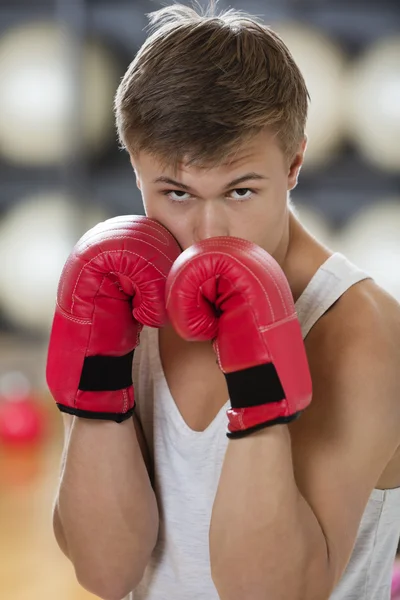 Confident Young Man Boxing In Gym