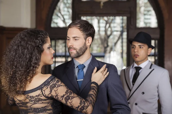 Man And Woman Performing Tango By Young Partner