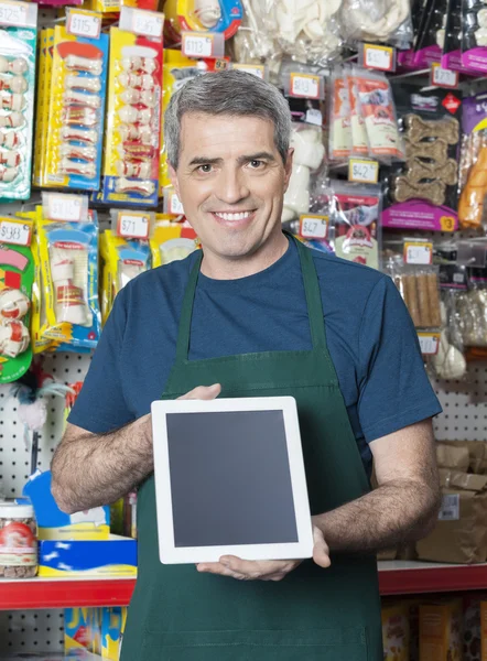 Salesman Showing Digital Tablet With Blank Screen In Pet Store